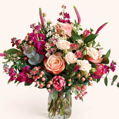 Bouquet of flowers in a clear vase on a white background